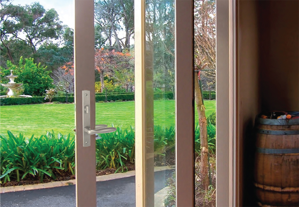 A large custom bifold door connects the outdoor space to the interior living space. 