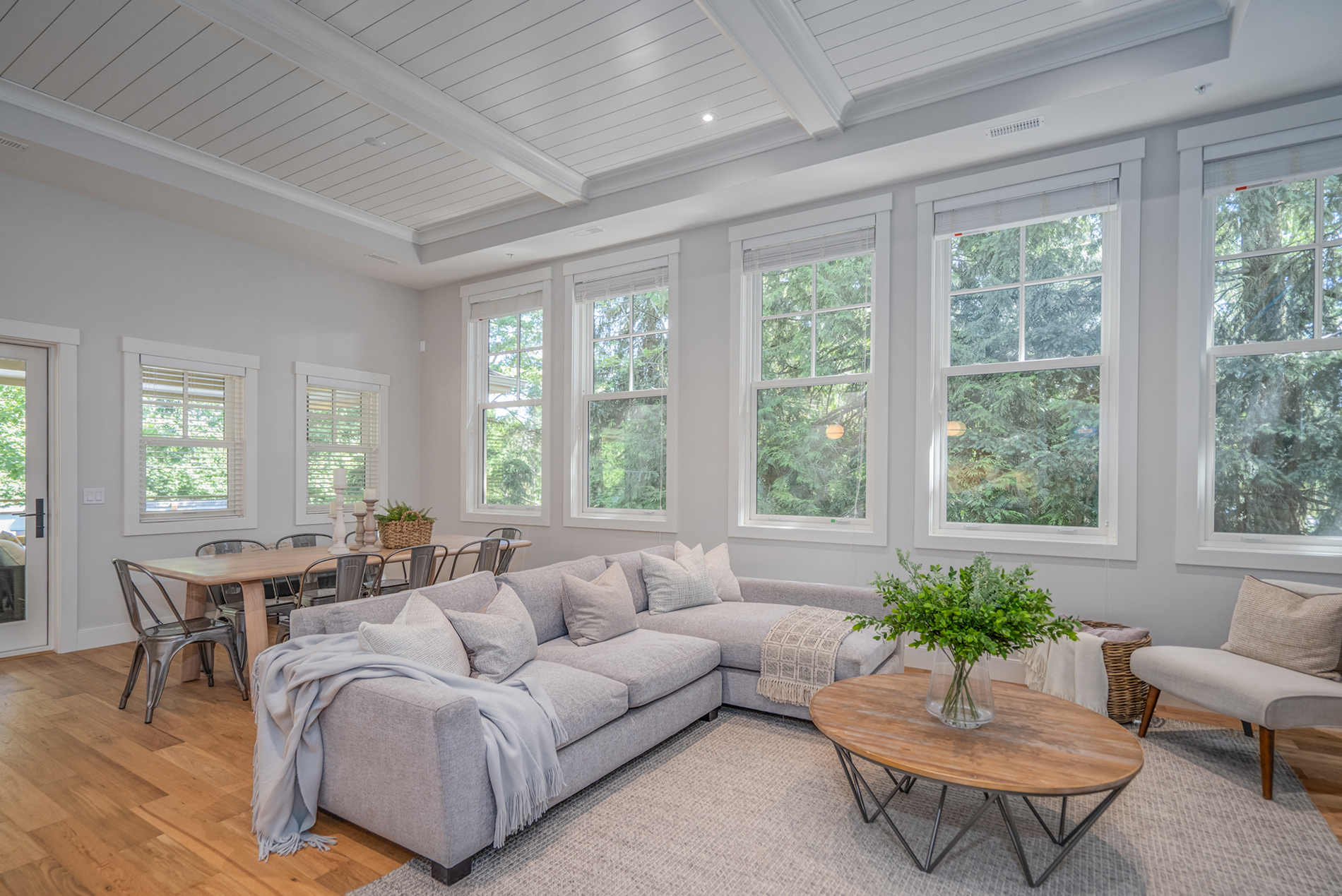 Traditional style living room with west coast elements in a heritage home that has white classic vinyl windows by Centra