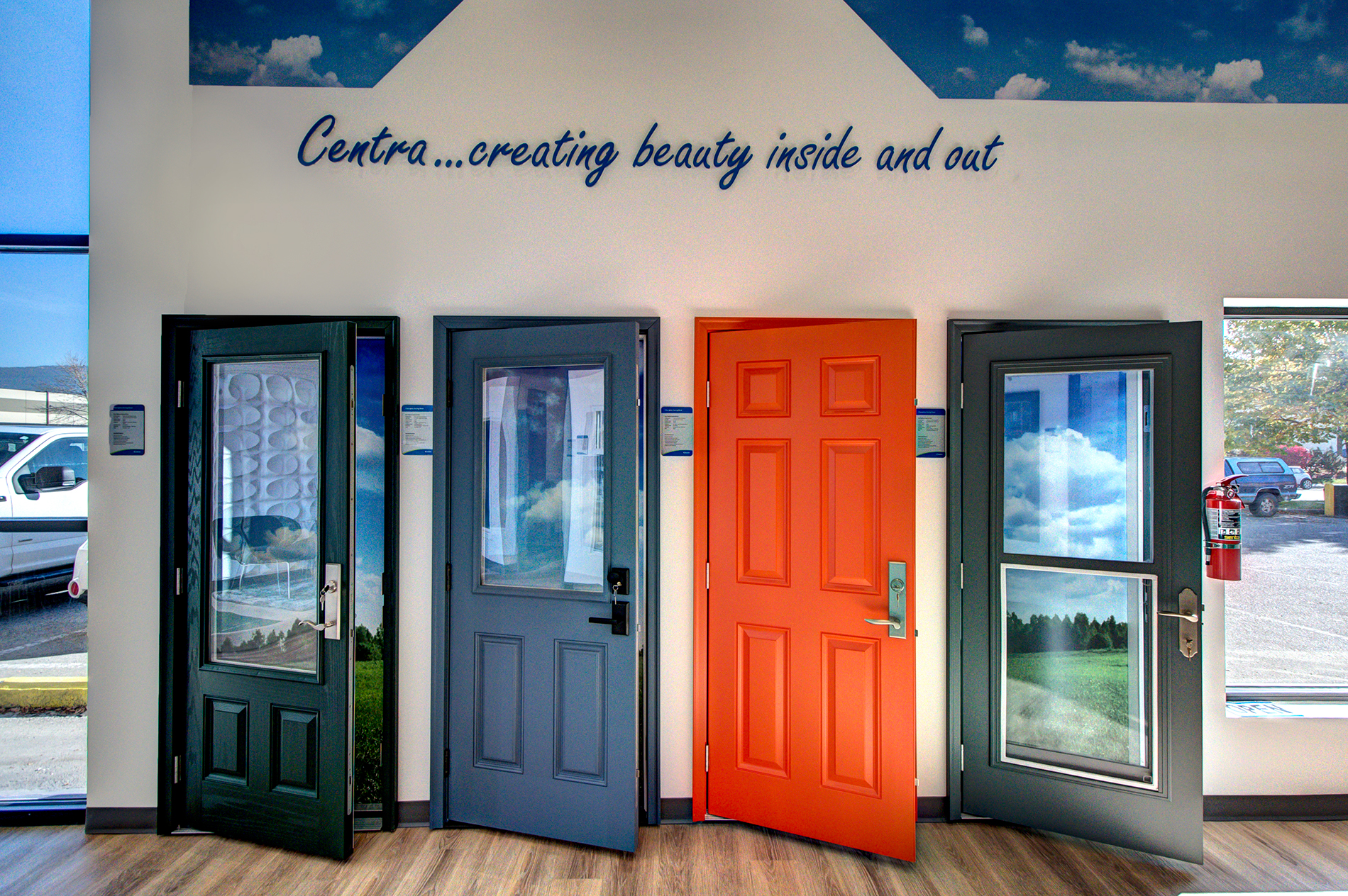 Collection of Entry Doors styles in black, red, and blue at the Centra showroom in Kelowna.